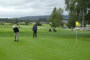 Harry Coe on the putting Green at Ludlow. Martin Dinkele looks on