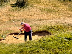 Austin Jessop exiting one of the course's many bunkers